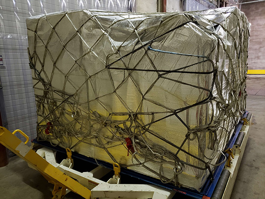 The PMC aircraft pallets are loaded with chilled pork that has been wrapped in thermal sheet, netted, CFIA sealed, and ready to be loaded onto the aircraft at Edmonton International Airport for export to China