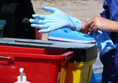 Close up photograph of a person putting on nitrile gloves