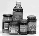 This image shows regular cylindrical glass and plastic bottles and jars, such as jars of sauce. For this category, the ADS calculation includes the full circumference of the sides measured from the heel of the jar to the curve of the neck, and the lid unless a specific exception applies.