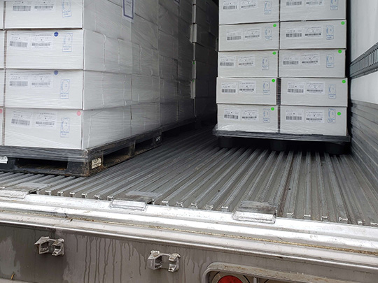 Unloading of pallets of chilled pork under CFIA supervision at Edmonton International Airport