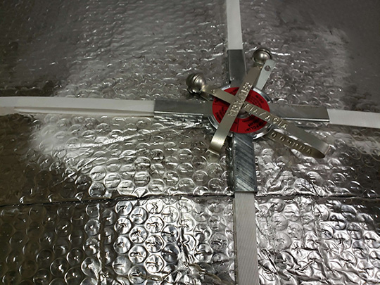 Under CFIA oversight, official seals are re-applied on top of the chilled pork shipment at Edmonton International Airport