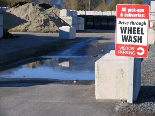 Une photo d'un panneau de biosécurité sur un poteau en avant. Description ci-dessous.